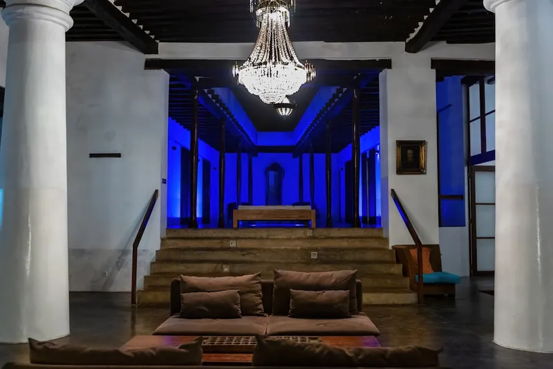 A living room with a couch and a chandelier